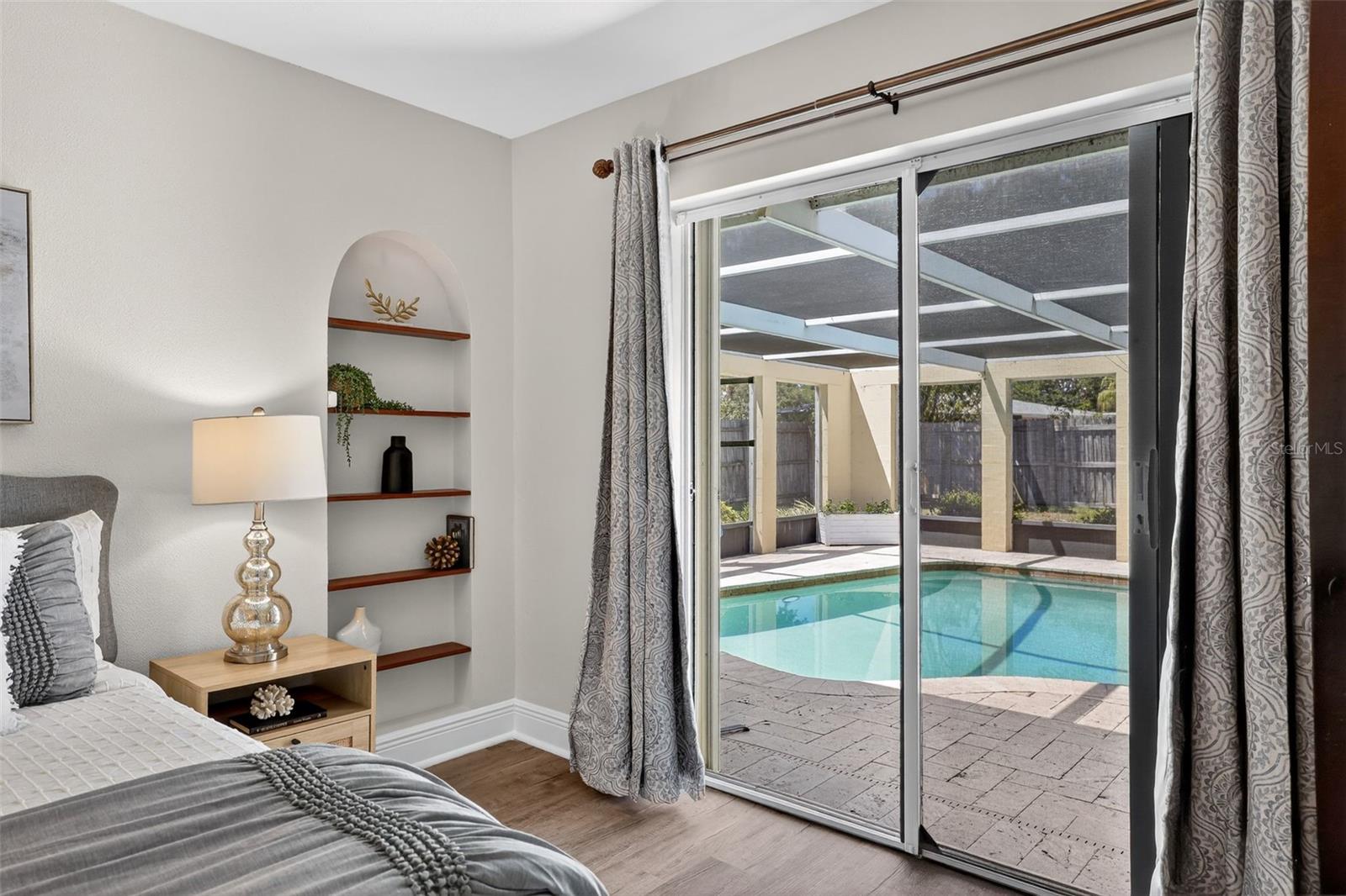 Walk out to the screened in pool from the primary bedroom