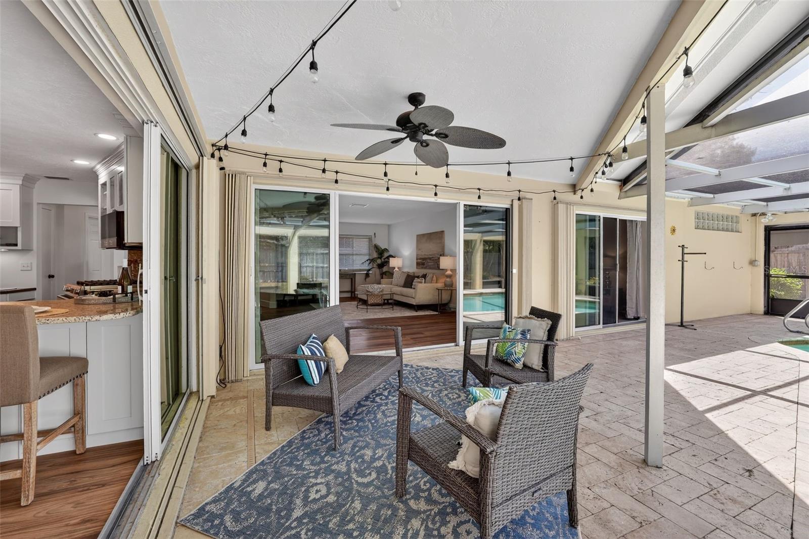 Walk out form the kitchen or living room to the pool area. Perfect indoor/outdoor living