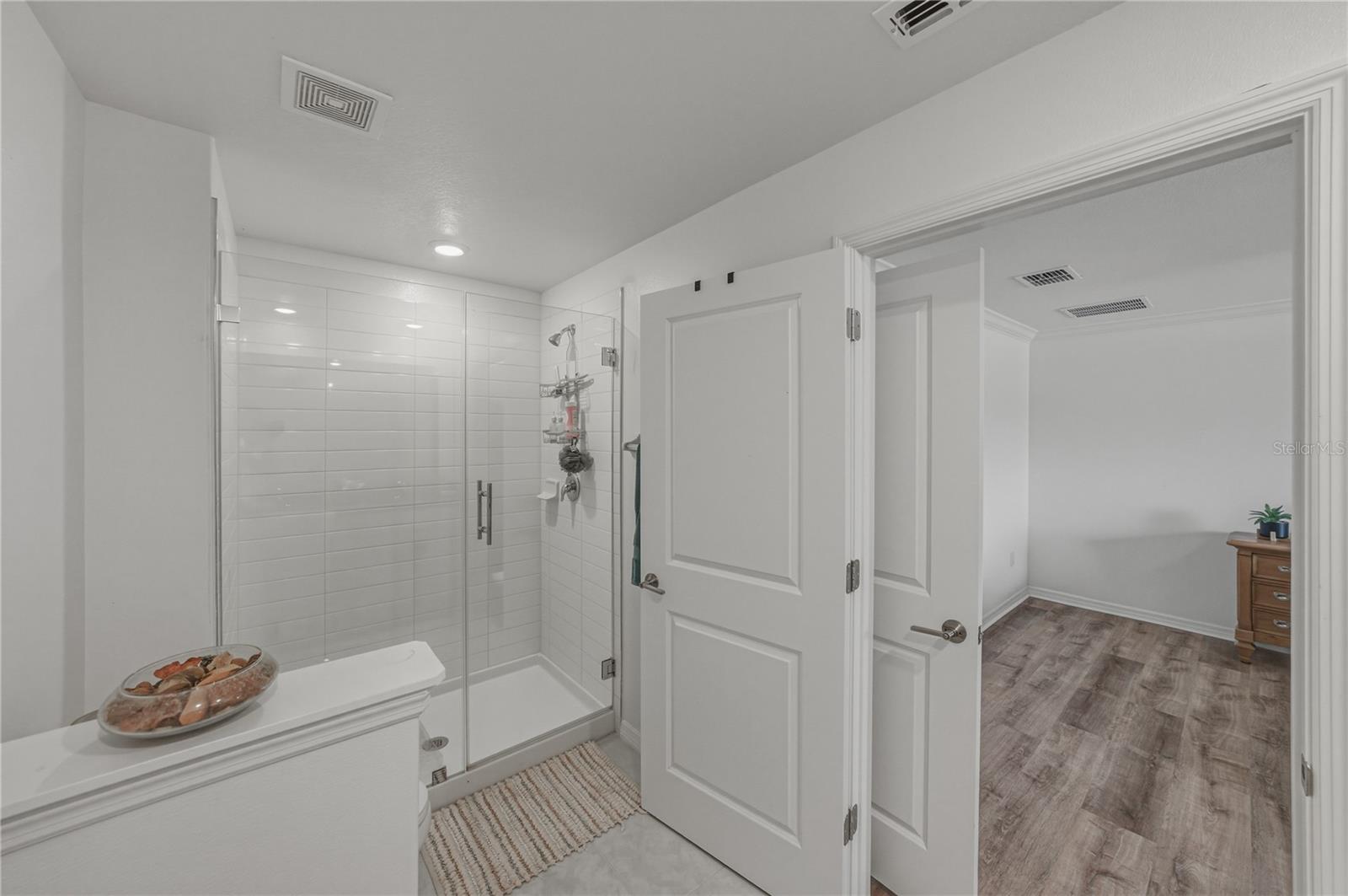 Primary Suite Bath with Privacy Toilet Wall and Tile Shower and Upgraded Frameless Shower Glass