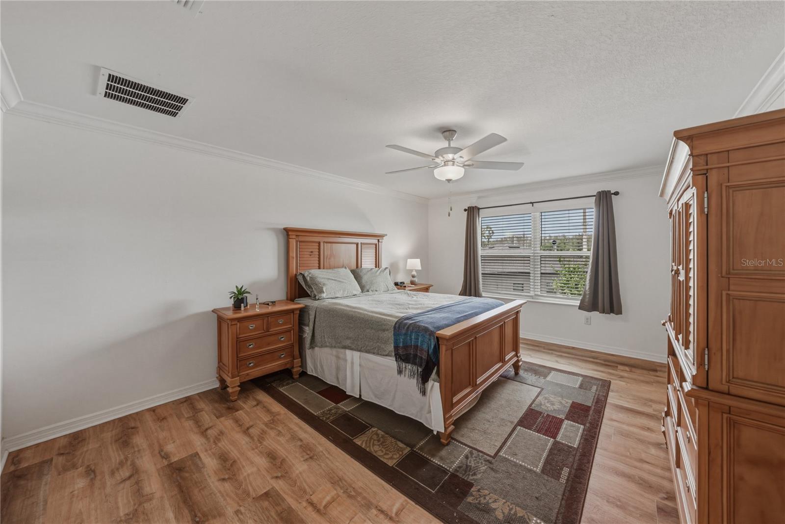 Primary Suite with Crown Molding and Ceiling Fan