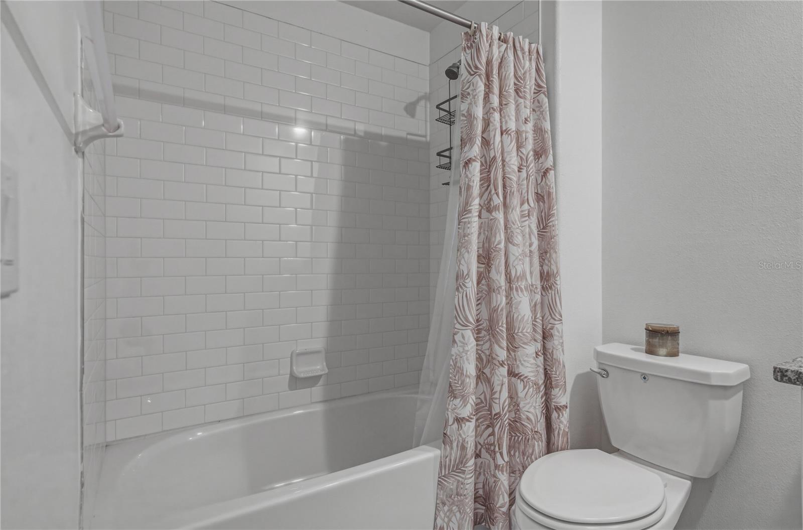 Full Second Bedroom Upstairs with Tile Surround, Square Undermount Sink and Granite Countertops.