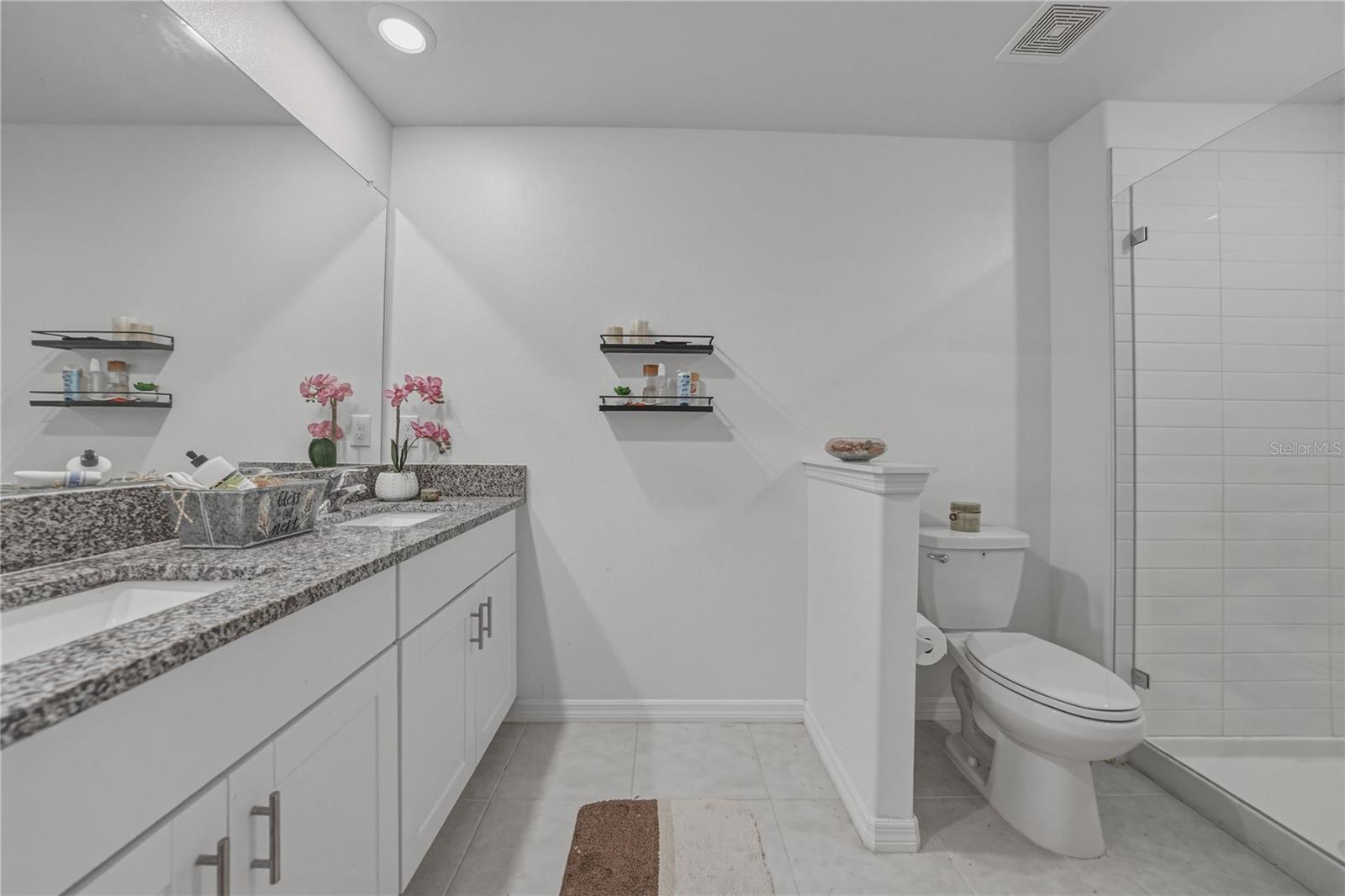 Primary Suite Bath with Dual Undermount Sinks, Granite Countertops, Full Overlay Shaker Cabinets and Hardware