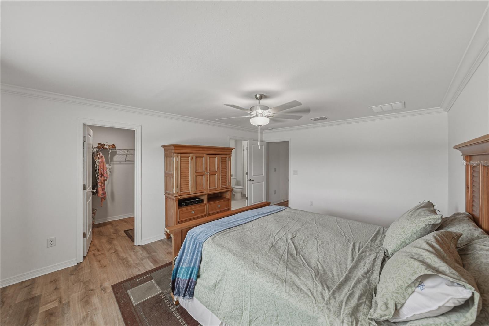 Primary Suite with Crown Molding and Ceiling Fan