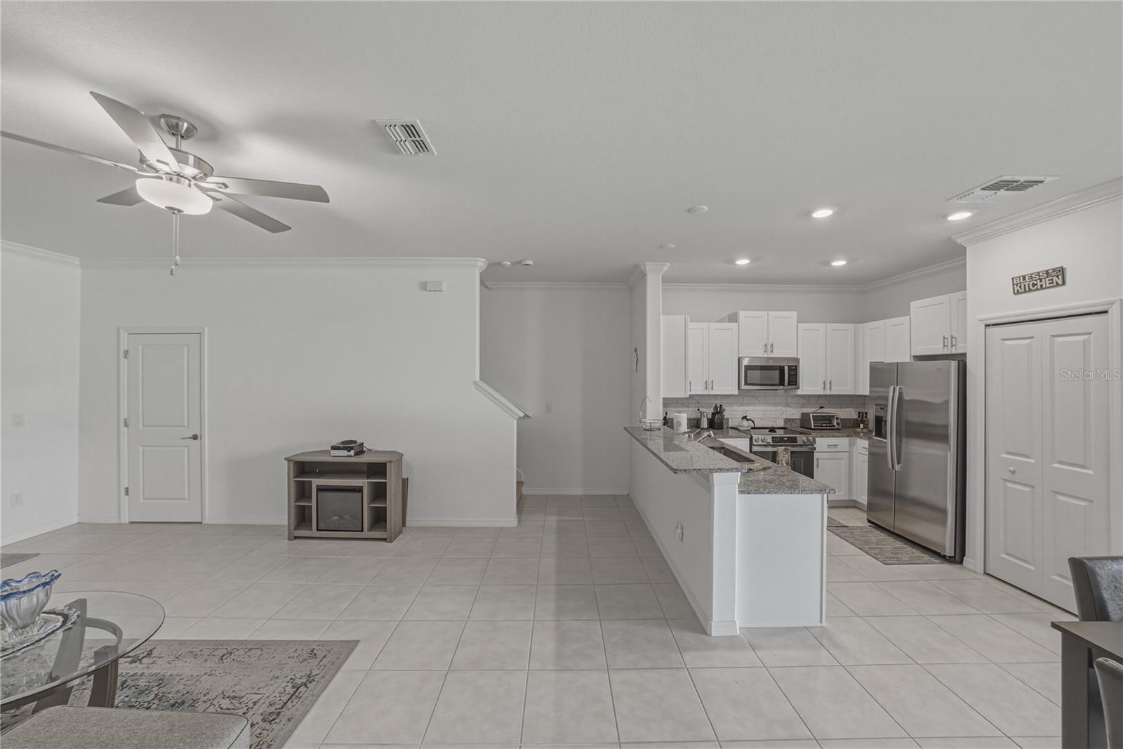 Open Living, Dining and Kitchen with Crown Molding