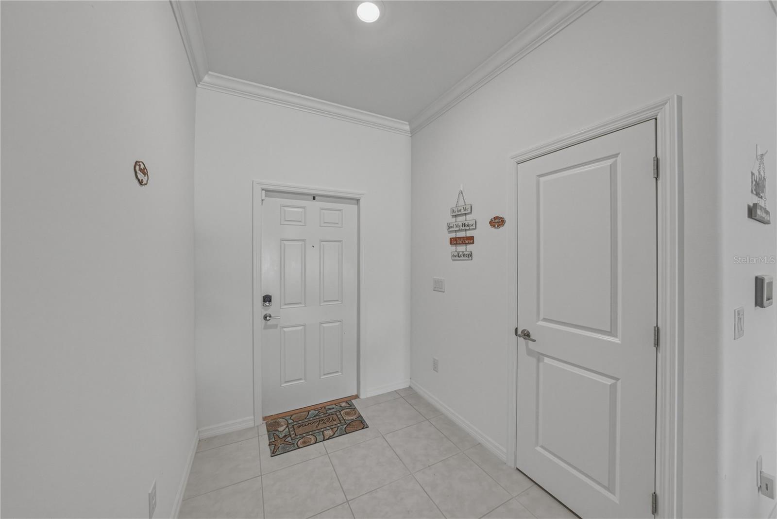 Entry Foyer with Crown Molding and Large Coat Storage Closet