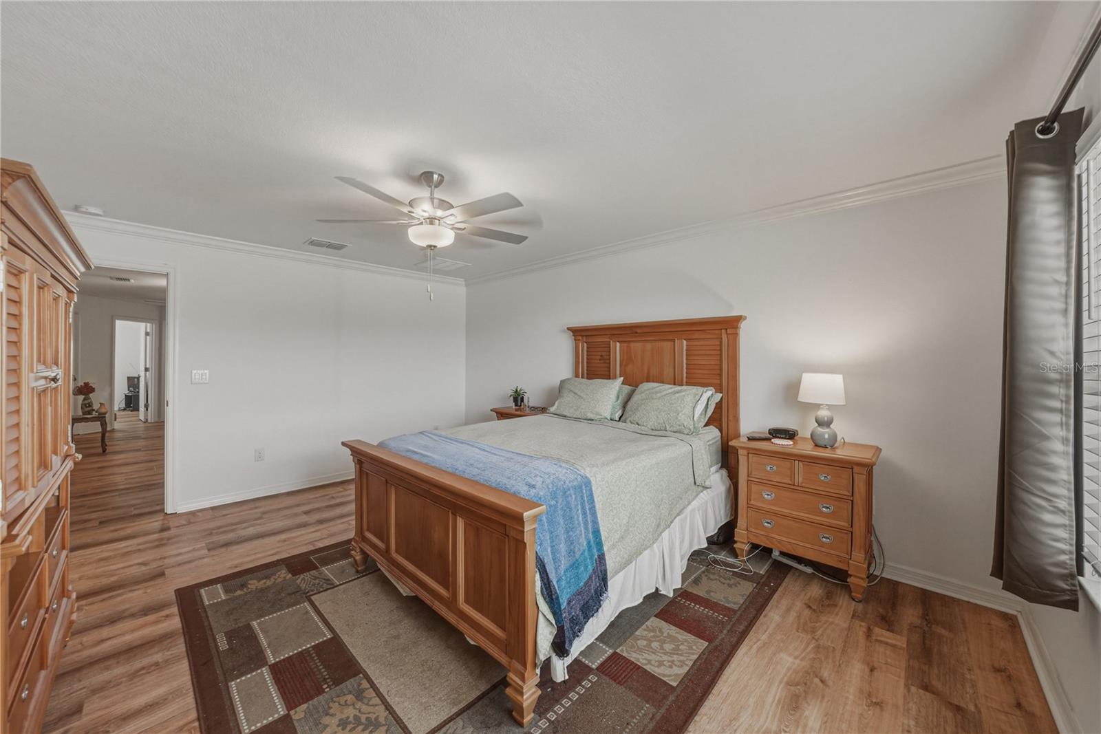 Primary Suite with Crown Molding and Ceiling Fan