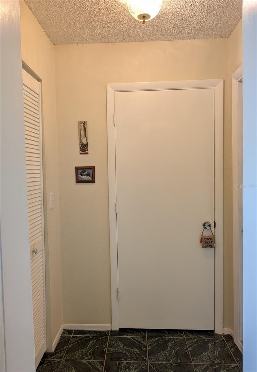 Hallway to Garage - Storage Closet to the left, 2nd Bathroom center and Garage to the right