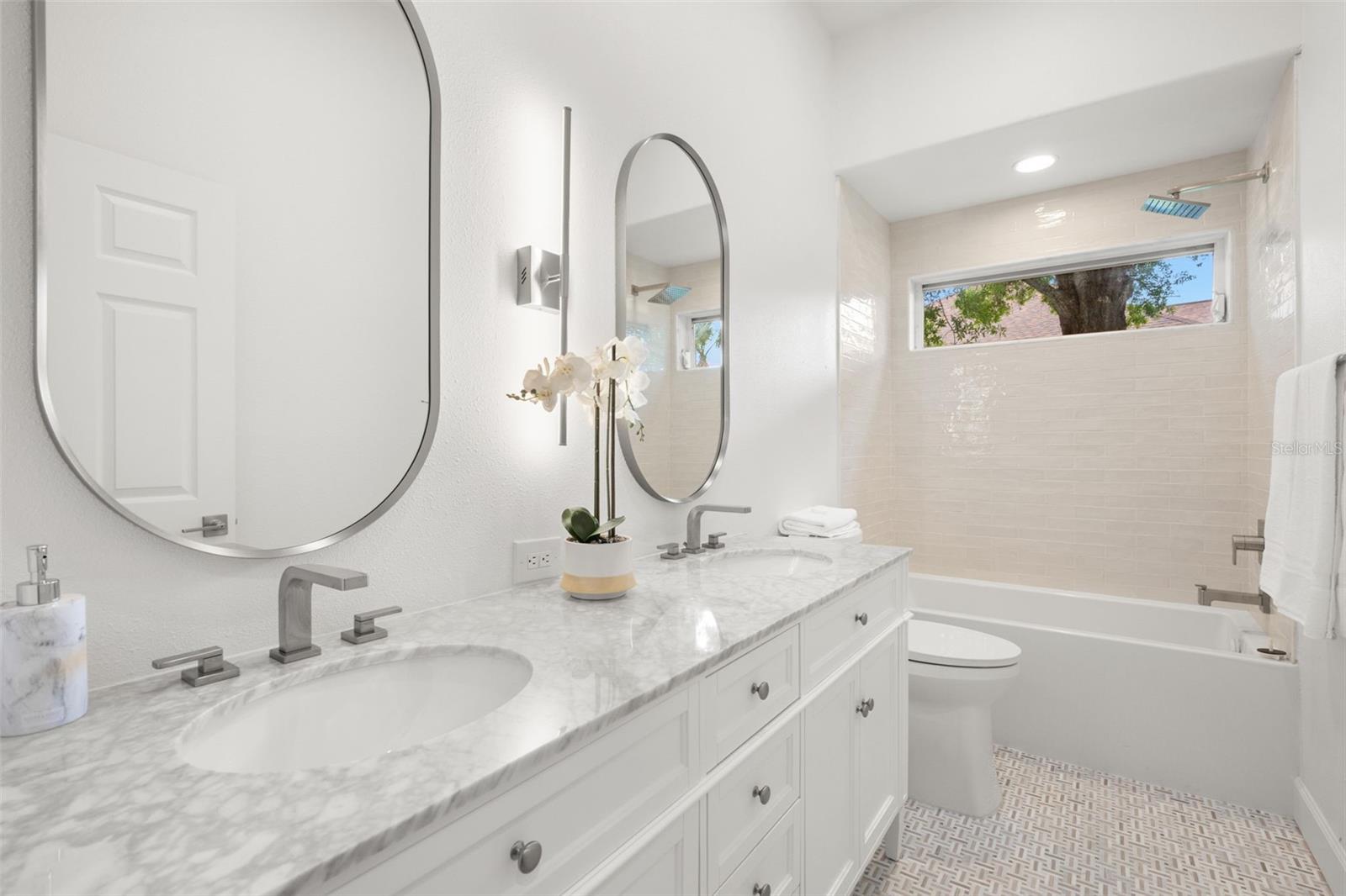Second fully updated bath with beautiful accents! Shared by bedrooms 2 & 3