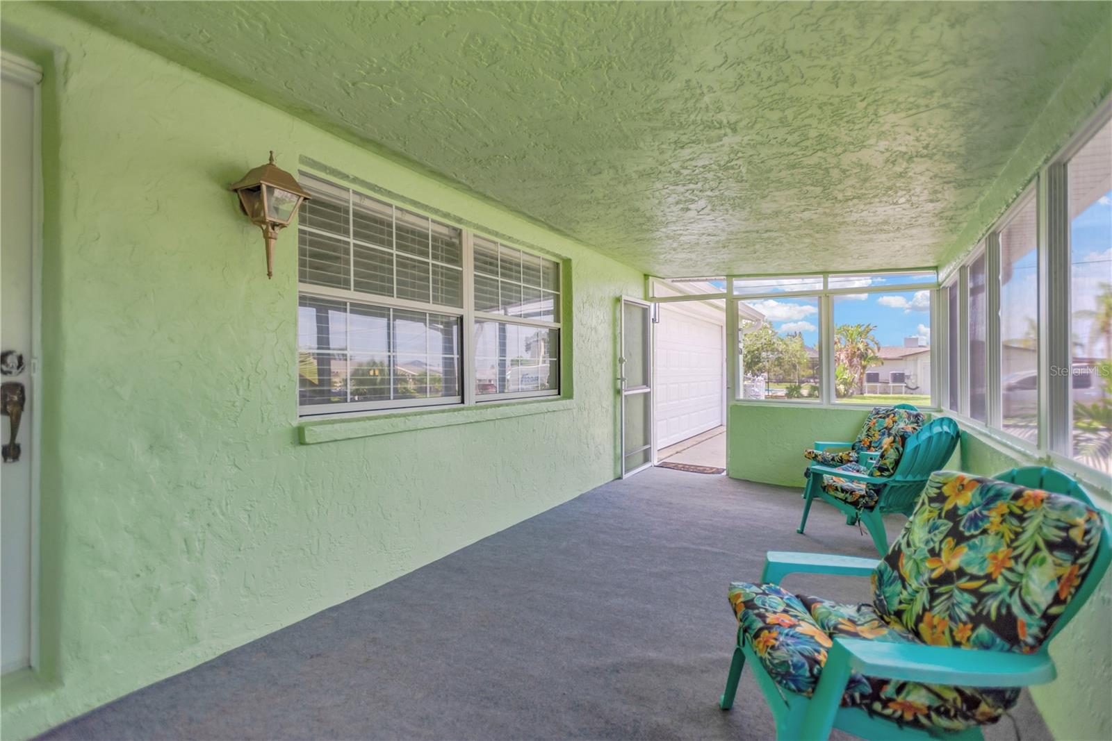 Enjoy relaxing on your spacious, enclosed front porch / Florida Room providing additional space for full year enjoyment.