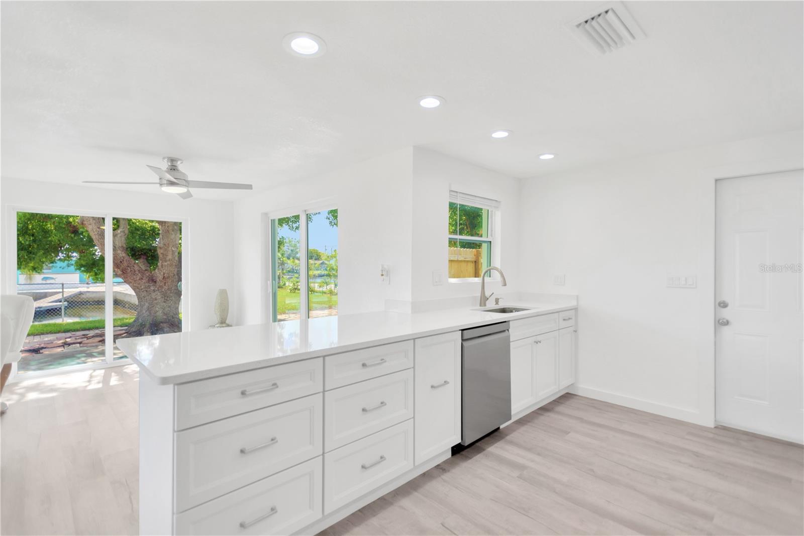 Enjoy the panaromic water view and green space as you work in the kitchen.  Preparing meals is a joy with the abundance of counter space and cabinets available to you.