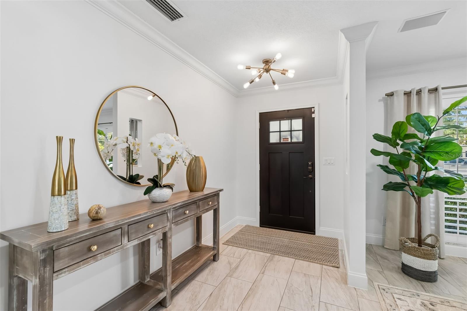 Spacious foyer with chic lighting.
