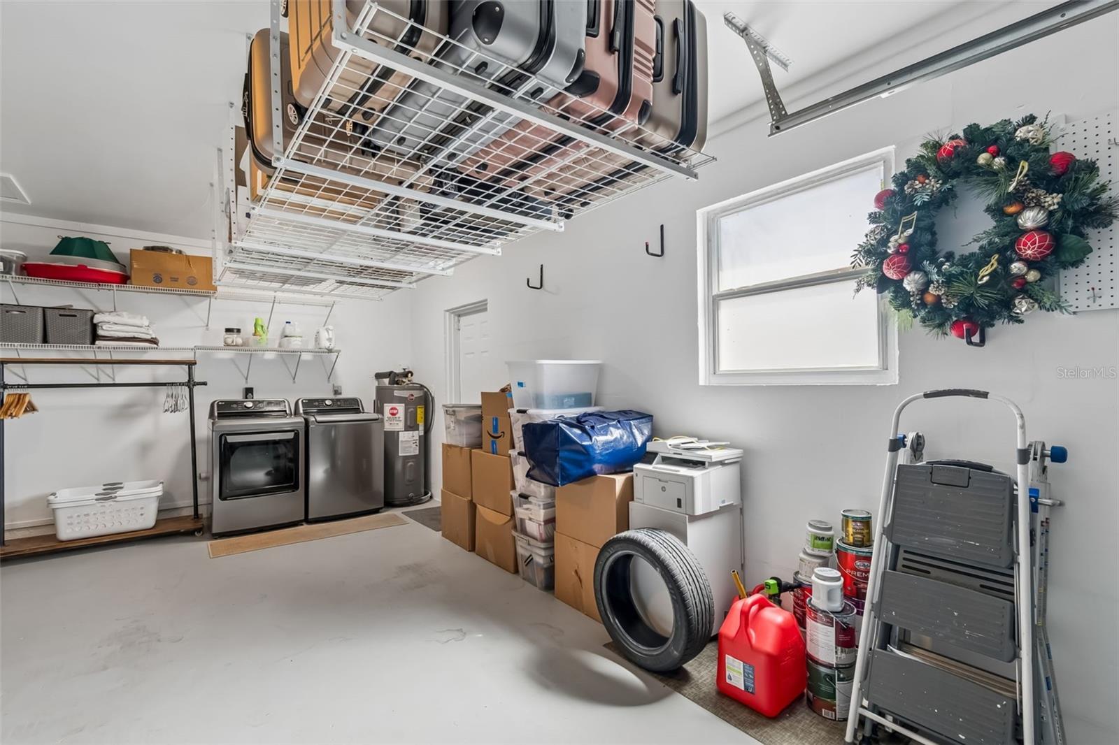 Two car garage and still plenty of room for washer and dryer. Notice the extra storage racks.