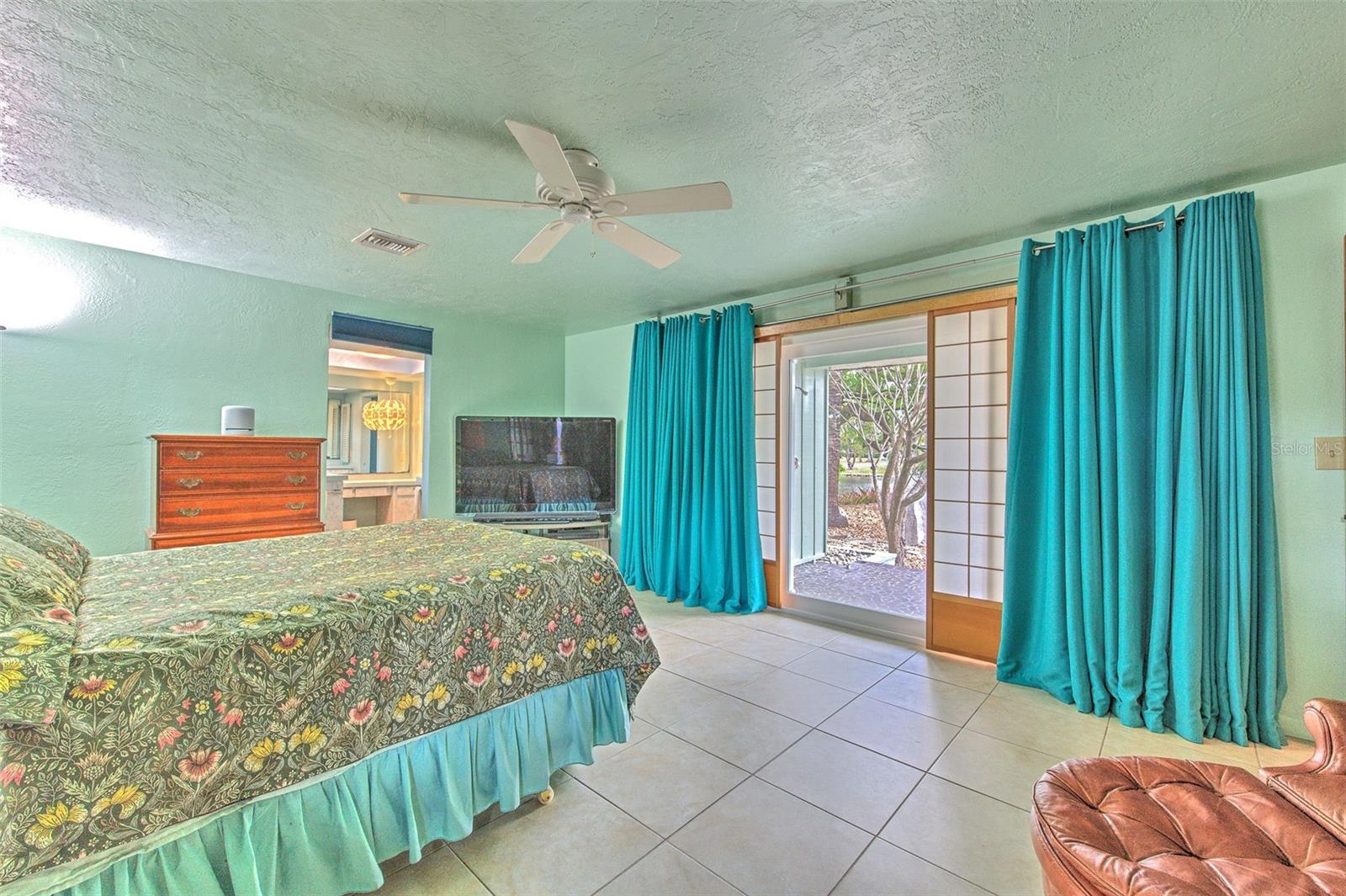 Master Bedroom 1 overlooking water and rock garden