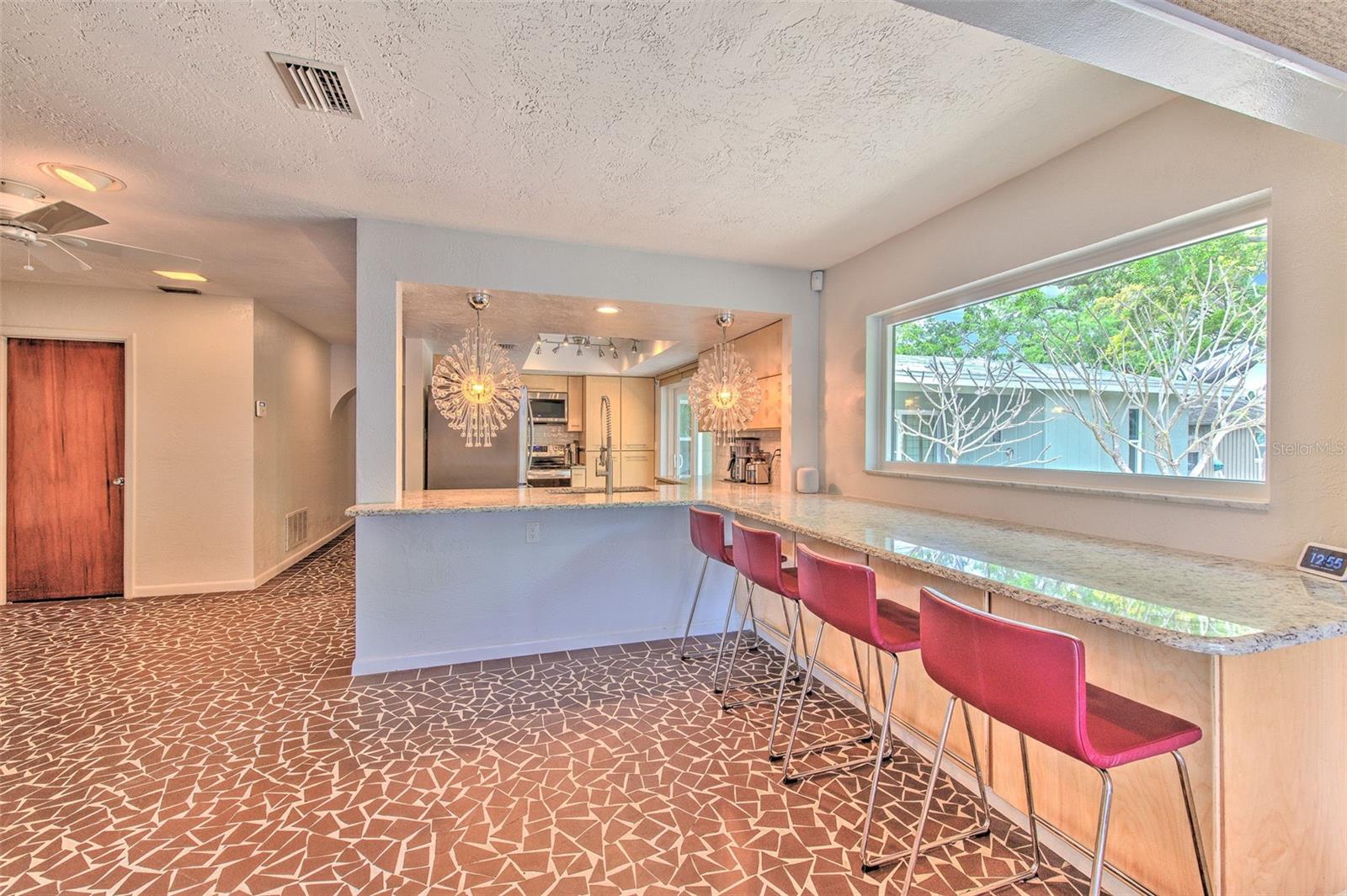 Beautifully Updated Kitchen w/ breakfast bar overlooking rock garden and water views