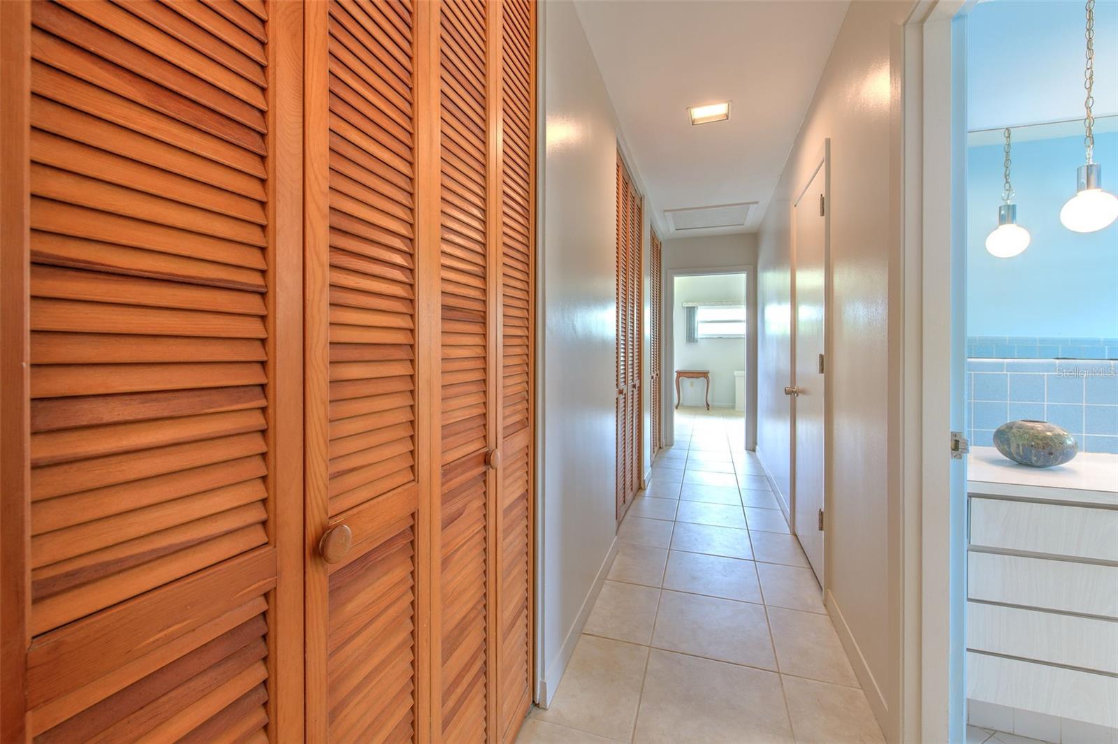 Long hallway with HUGE walk in closets. Tons of storage areas in this home