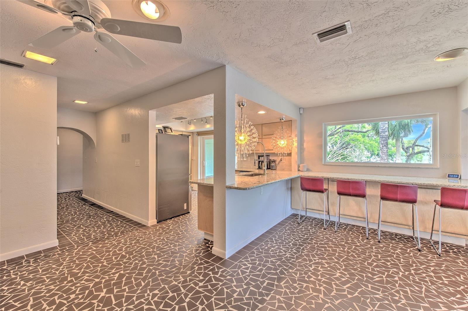 Beautifully Updated Kitchen w/ breakfast bar overlooking rock garden and water views
