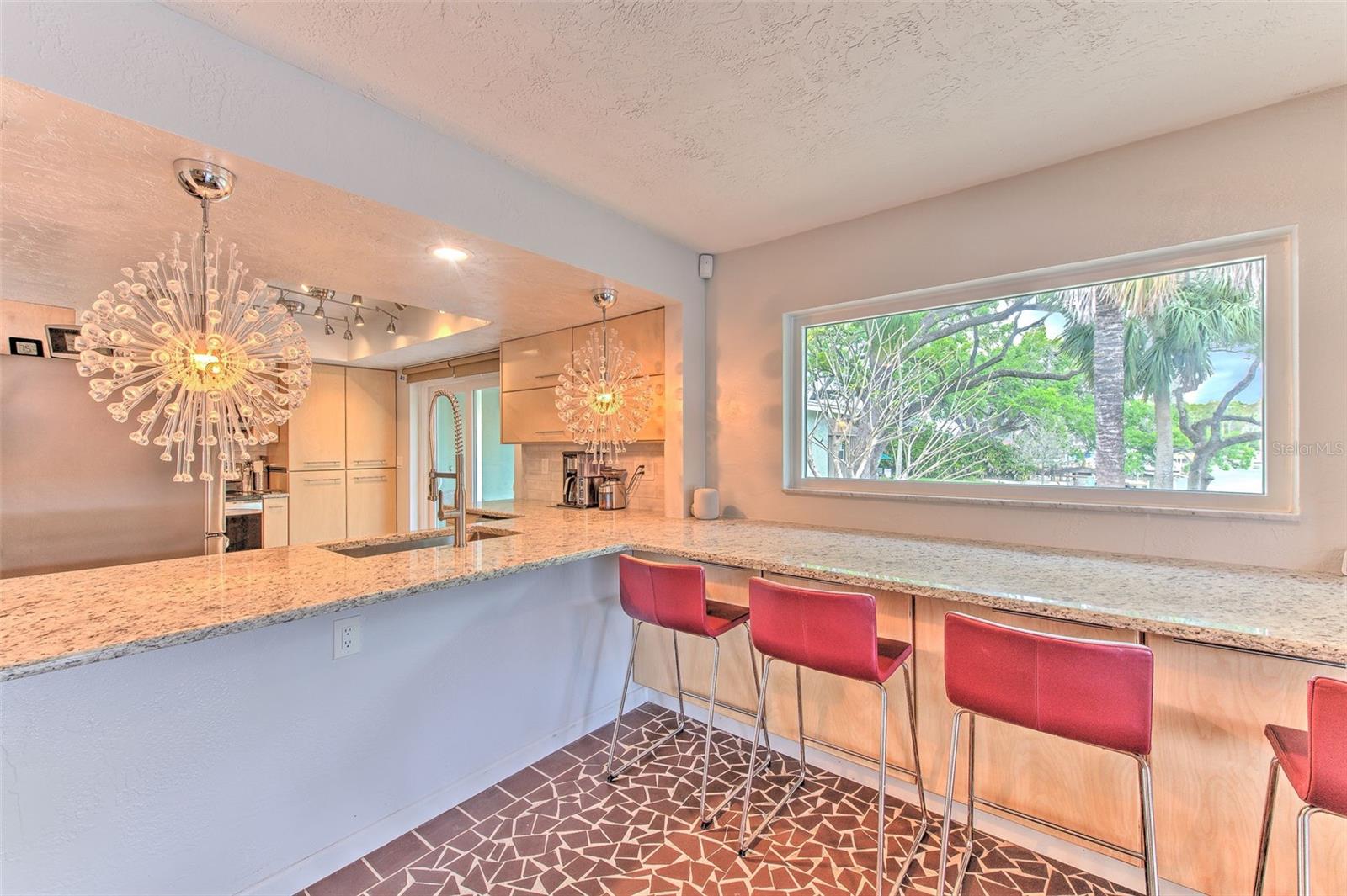 Beautifully Updated Kitchen w/ breakfast bar overlooking rock garden and water views
