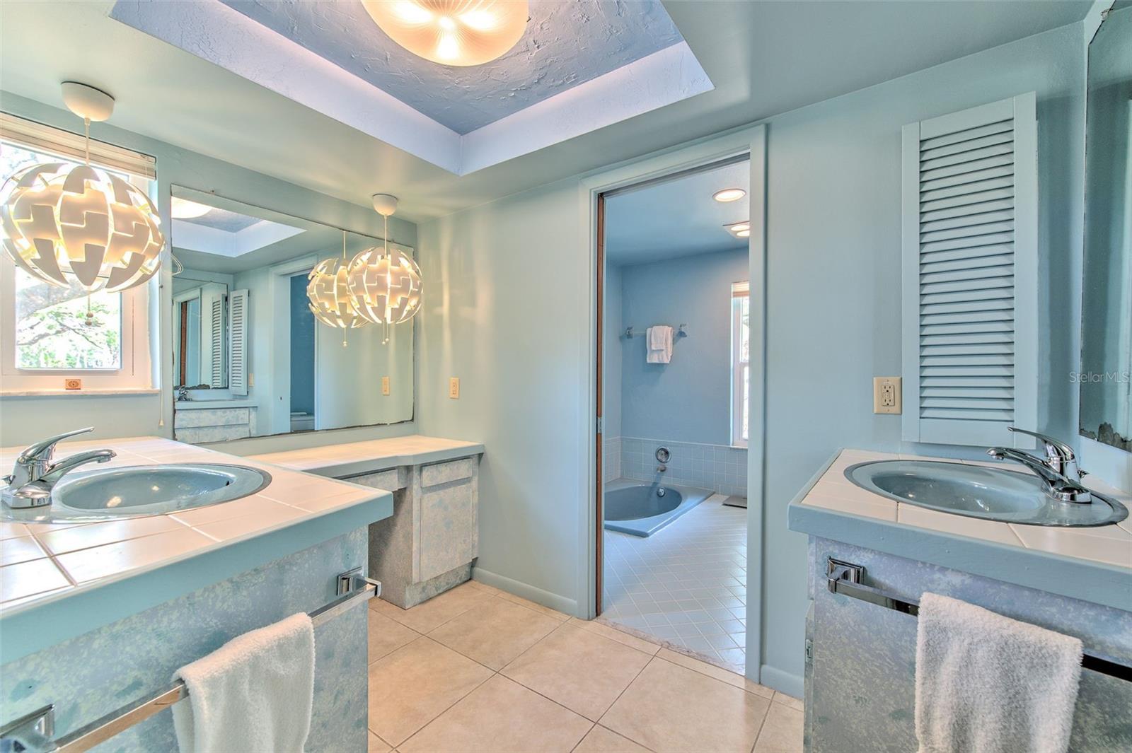 Master enSuite bathroom 1 with separate dual sink vanities and makeup vanity area
