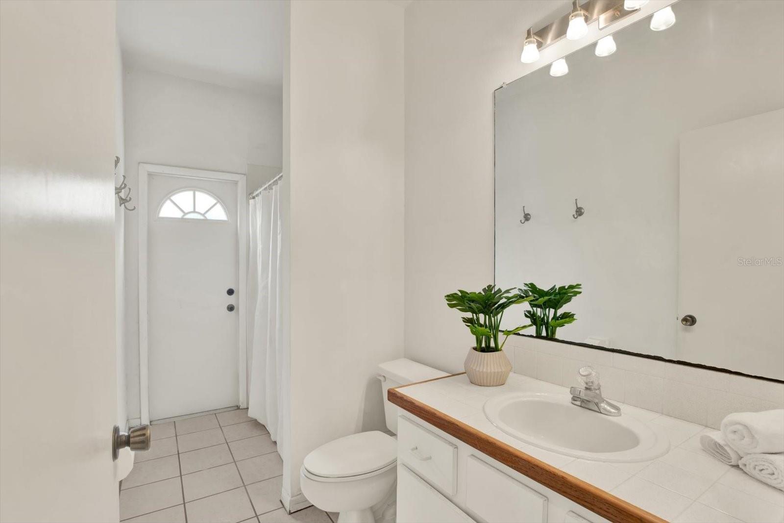 Full guest bath with patio access