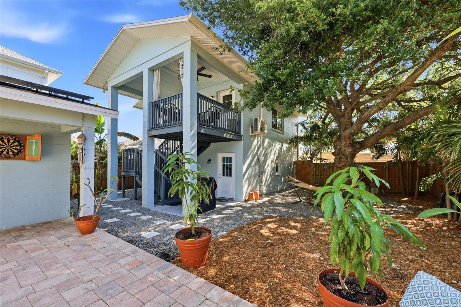Detached ADU above 2 car garage with private entrance and landscaped surroundings