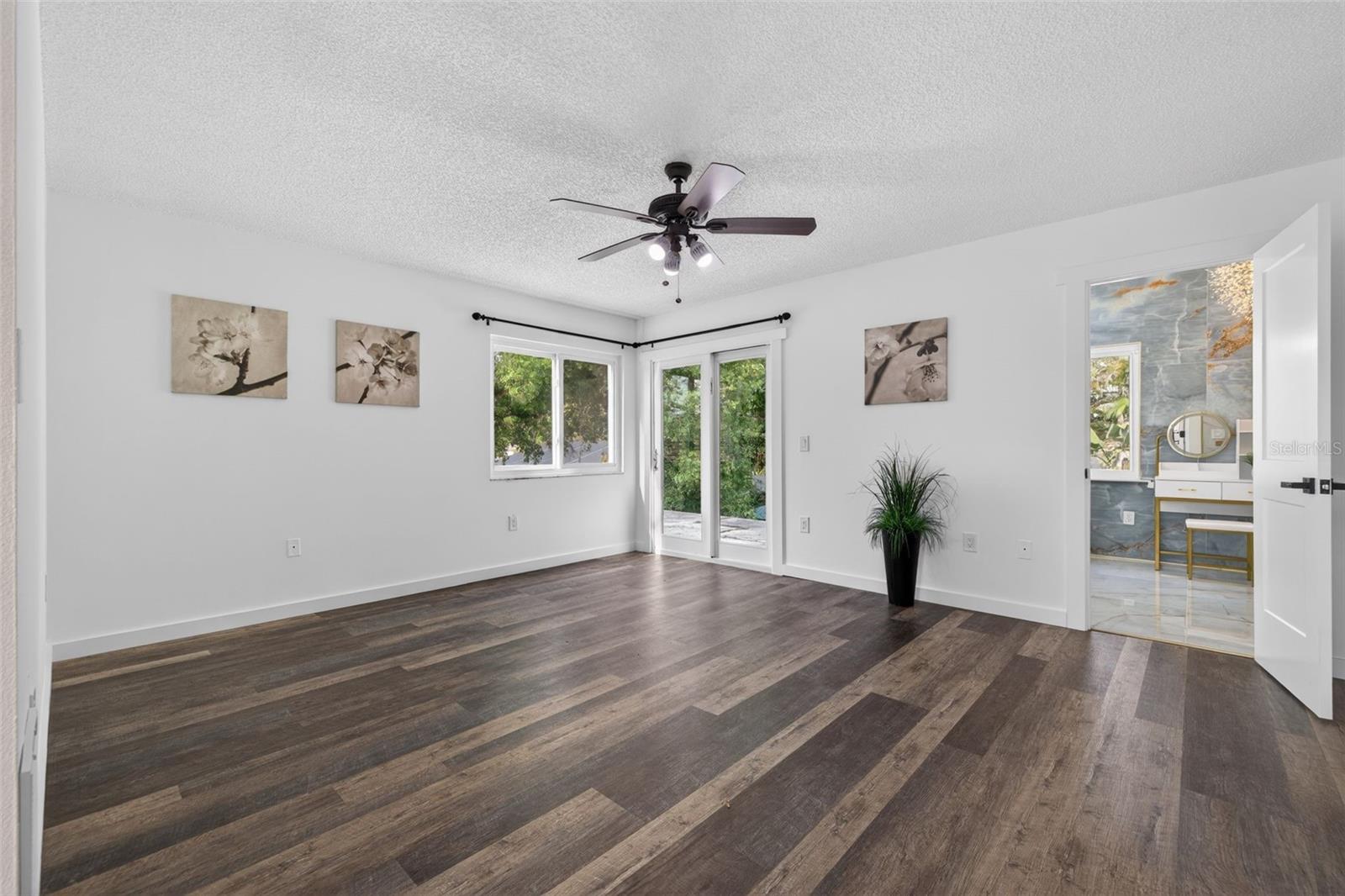 The top-level primary suite offers a private retreat and sliding doors overlooking the backyard with potential for a future balcony.