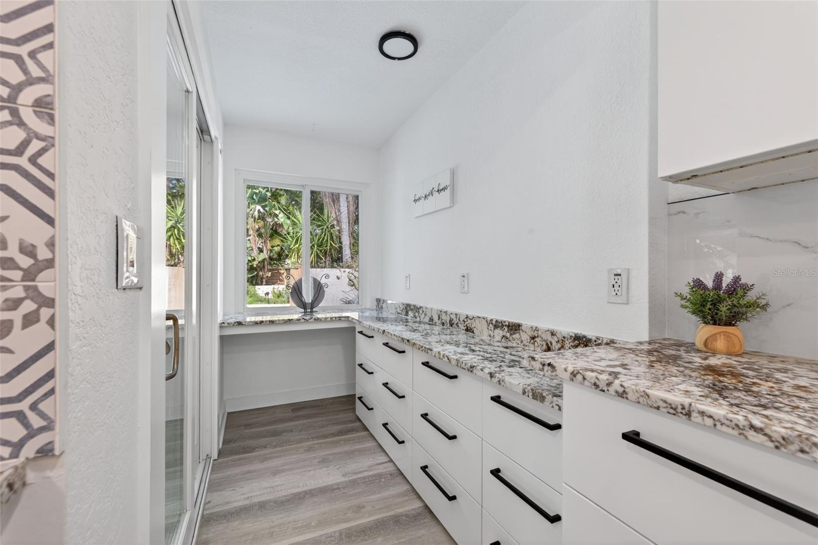 Kitchen offers this unique nook with extra storage and cabinets.