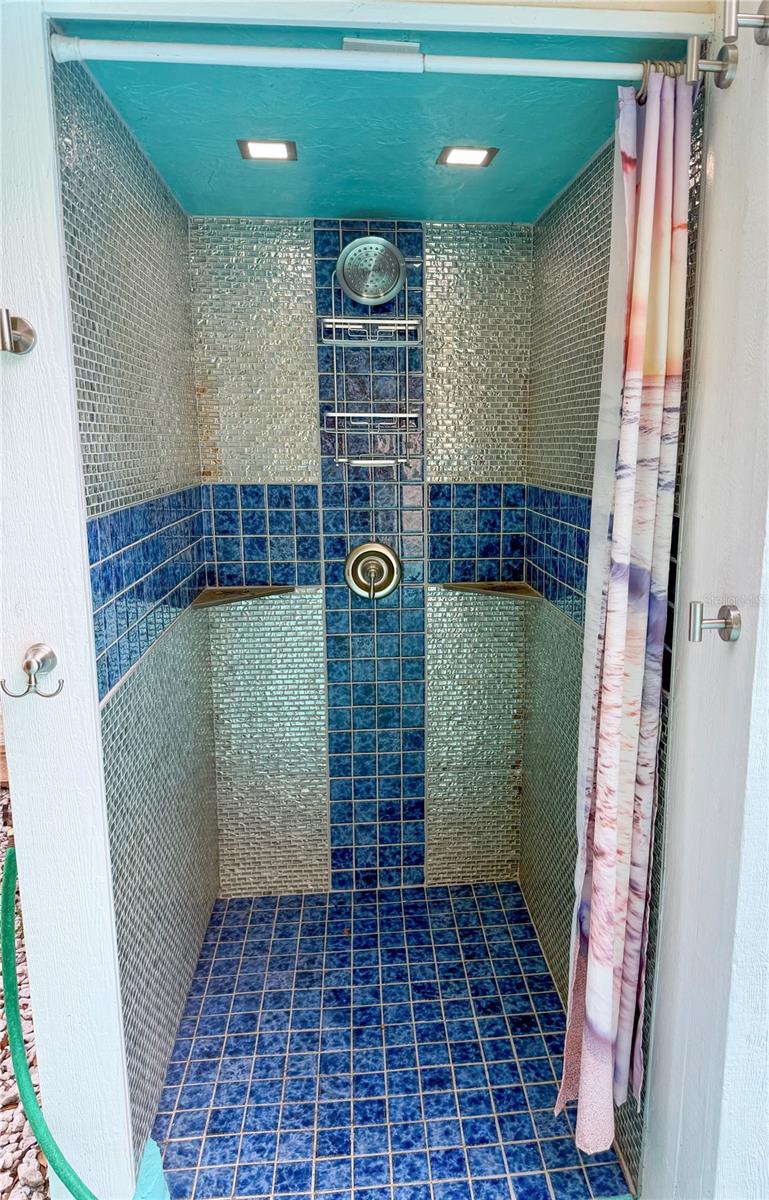 Outdoor shower with motion lights.