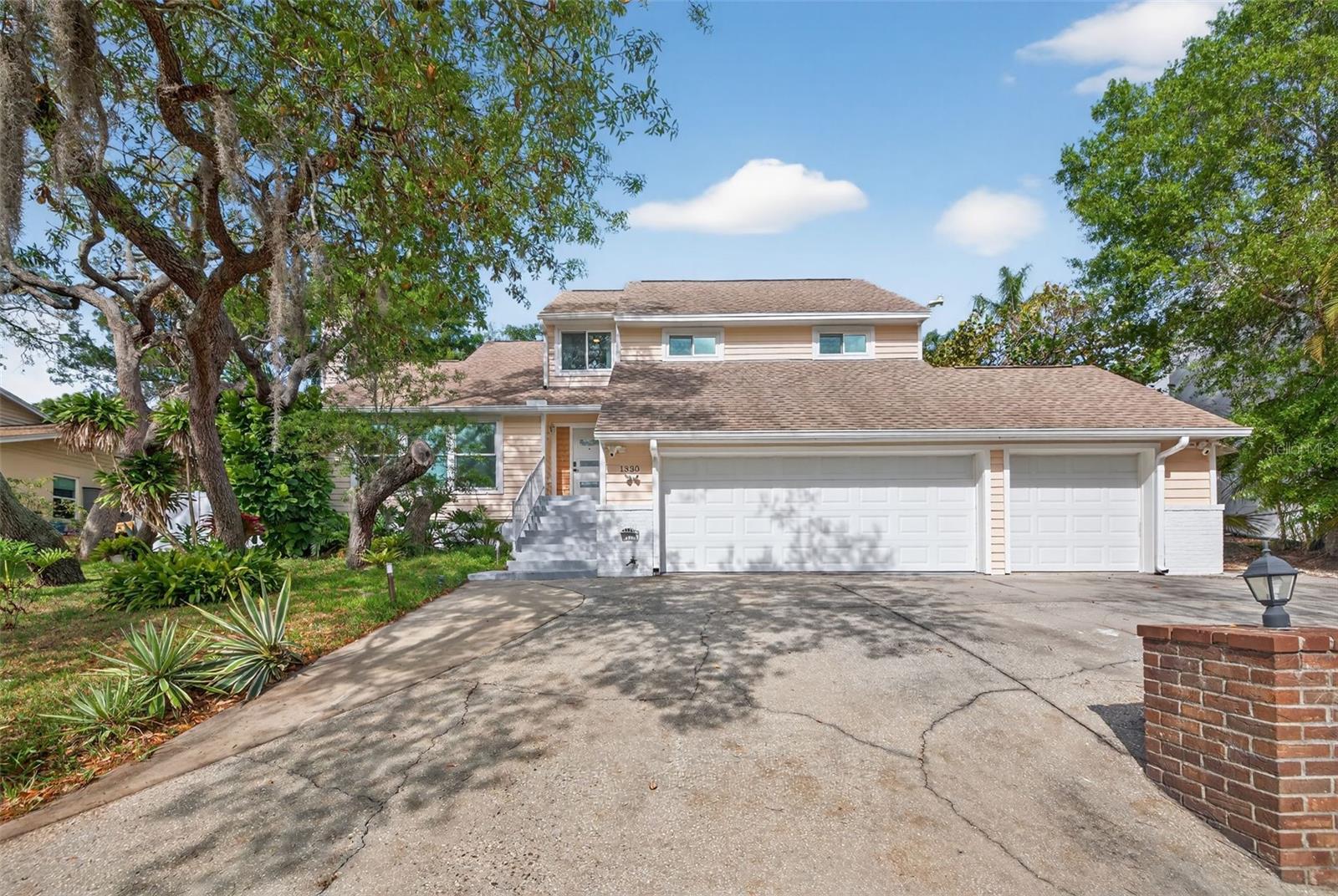 Additional features include a tankless water heater, attic fans, and cedar siding freshly painted in 2025.