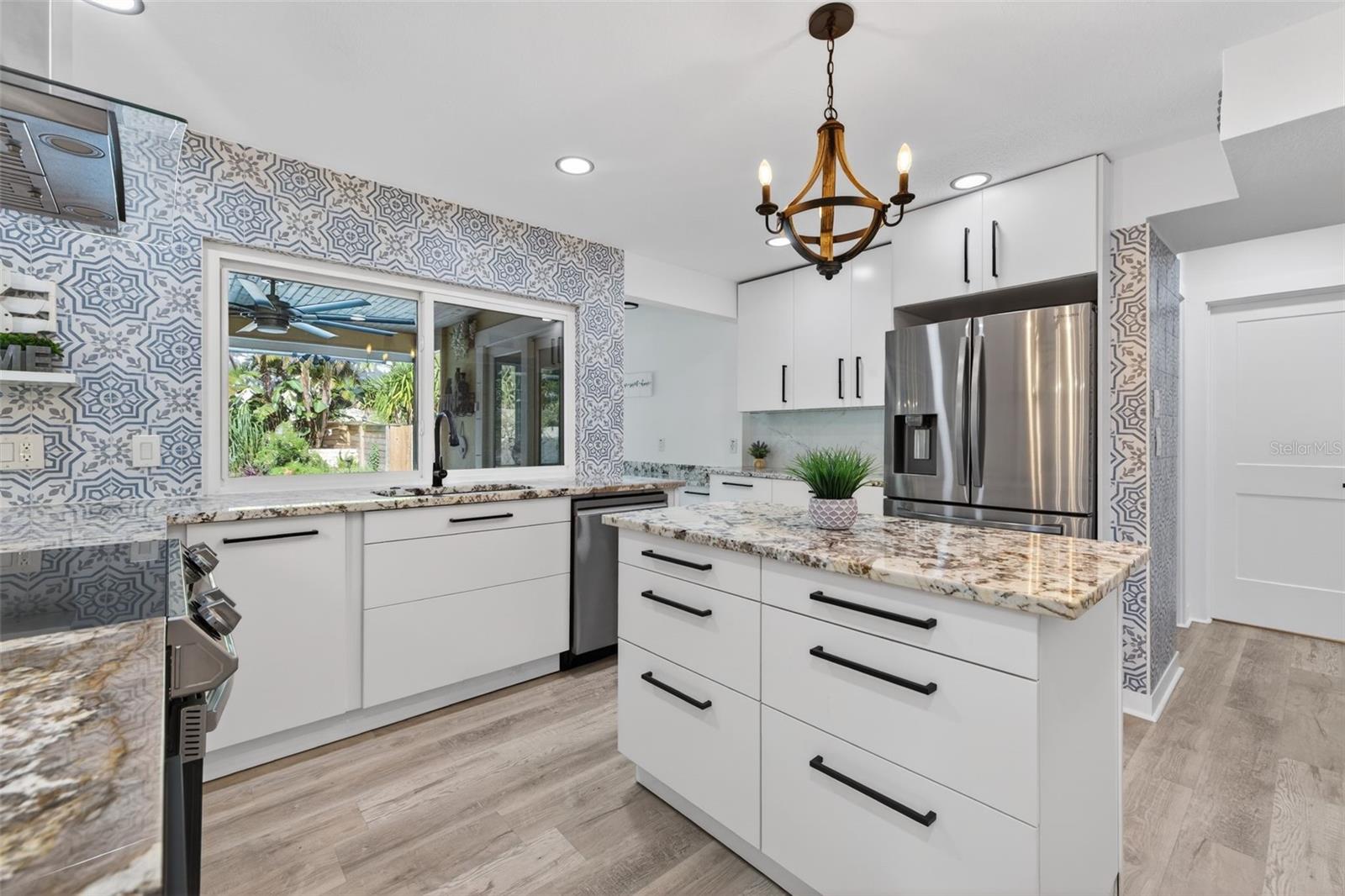 Kitchen features functional island, and ample prep and storage space.