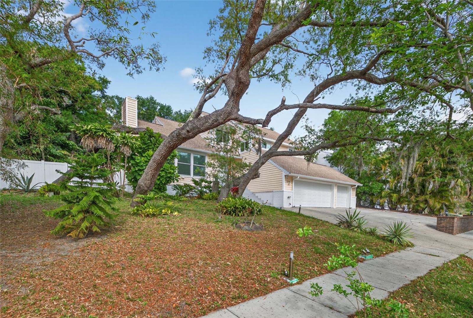 Major improvements include two energy-efficient HVAC systems (2023), hurricane impact windows with lifetime warranty (2019), hurricane-rated garage doors (2023), two 200-amp electrical panels (2023), and a 2018 roof.