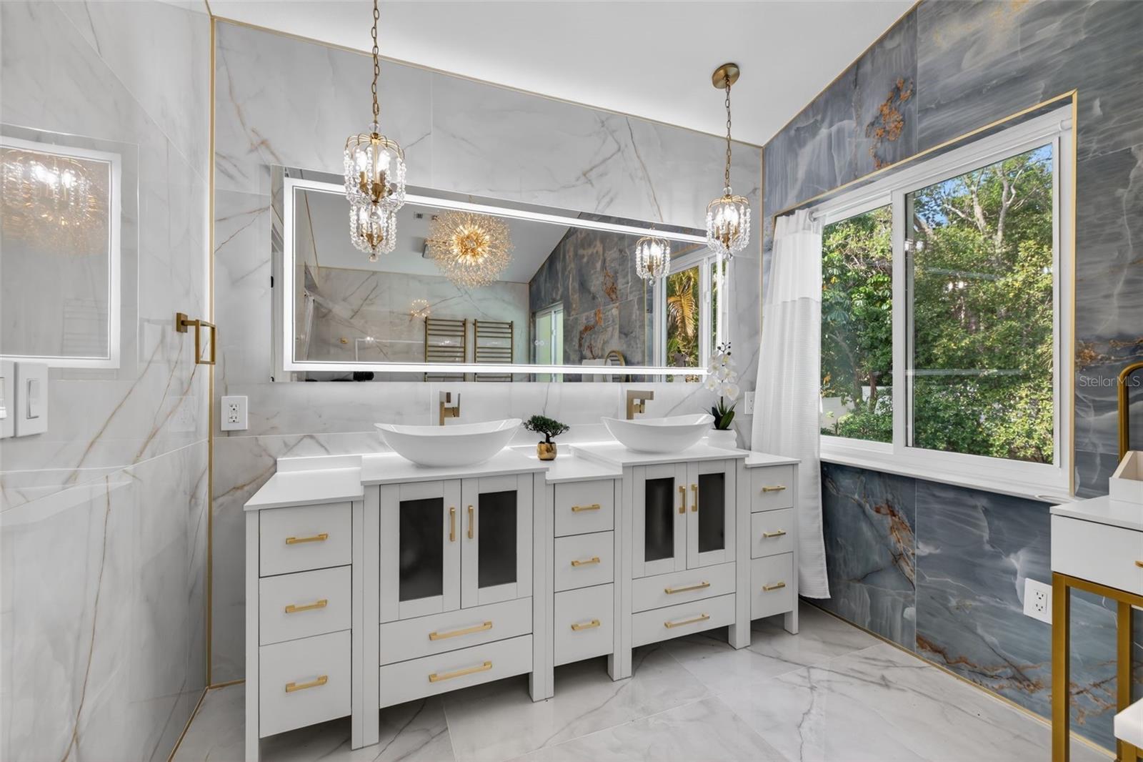 Master bathroom - dual vanity with large light up mirror.