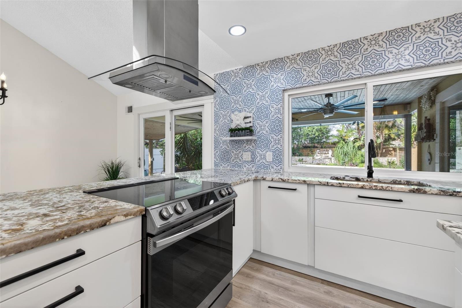 Recessed lighting throughout the kitchen area.
