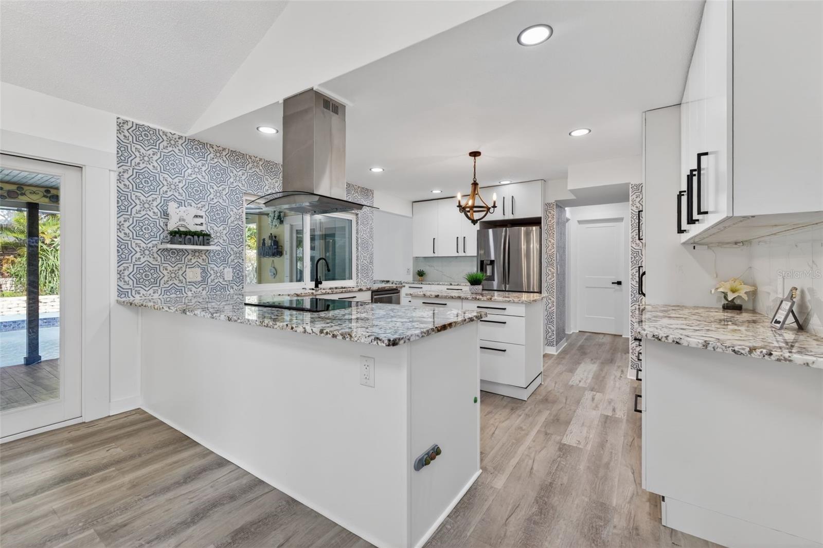 Kitchen offers soft-close cabinetry and granite countertops.