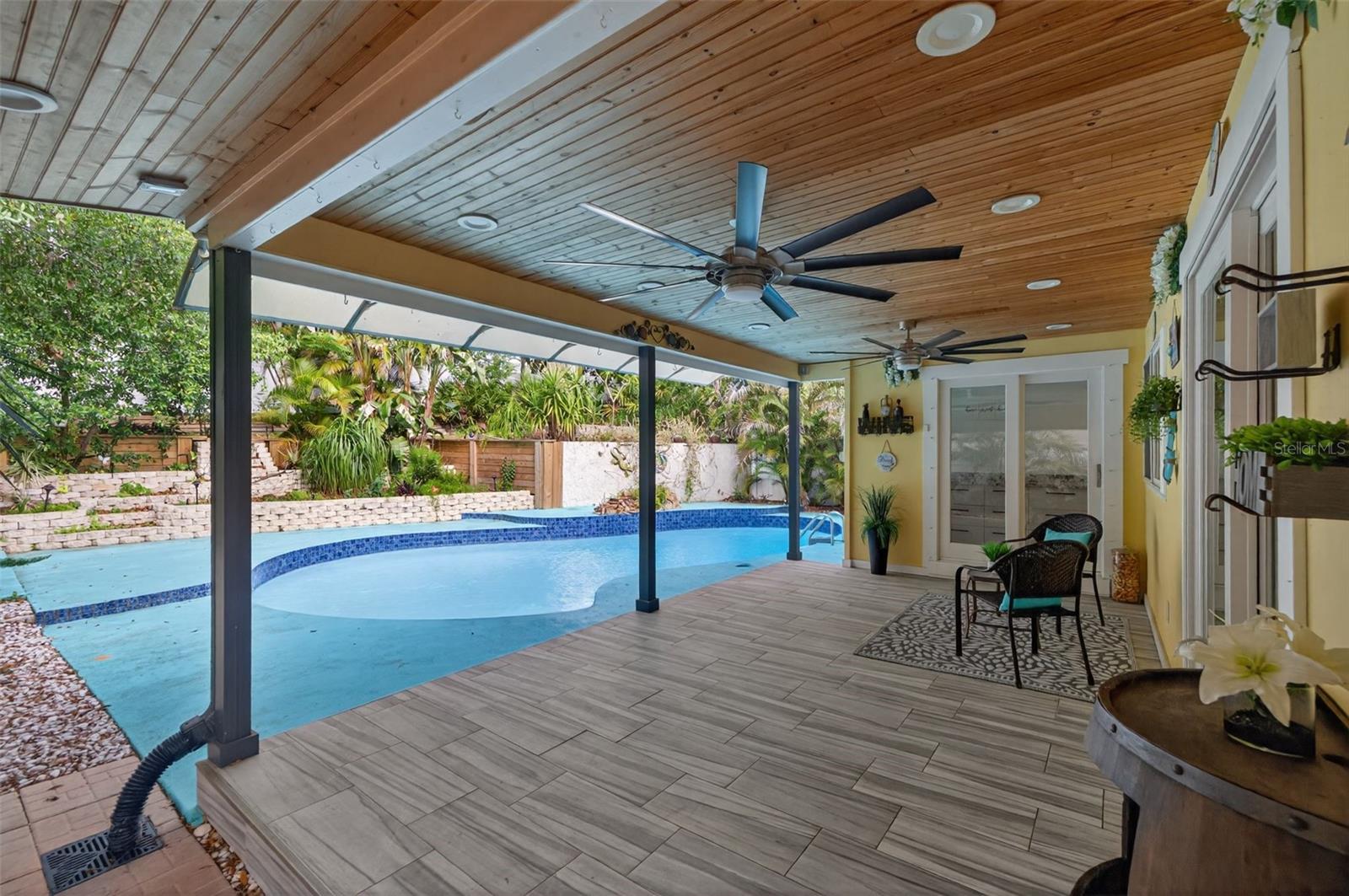 Outdoor area - covered back porch with 2 ceiling fans and dimmable recessed lighting.