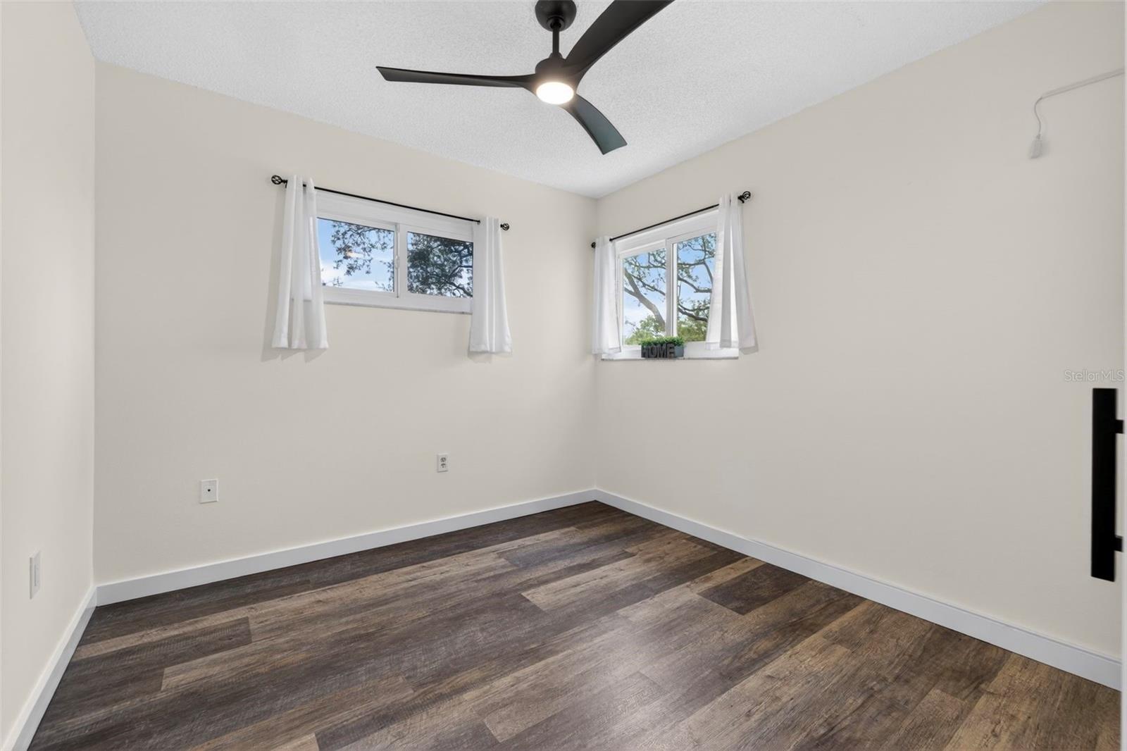 Bedroom #4 is featuring a ceiling fan, luxury vinyl flooring and built-in closet.