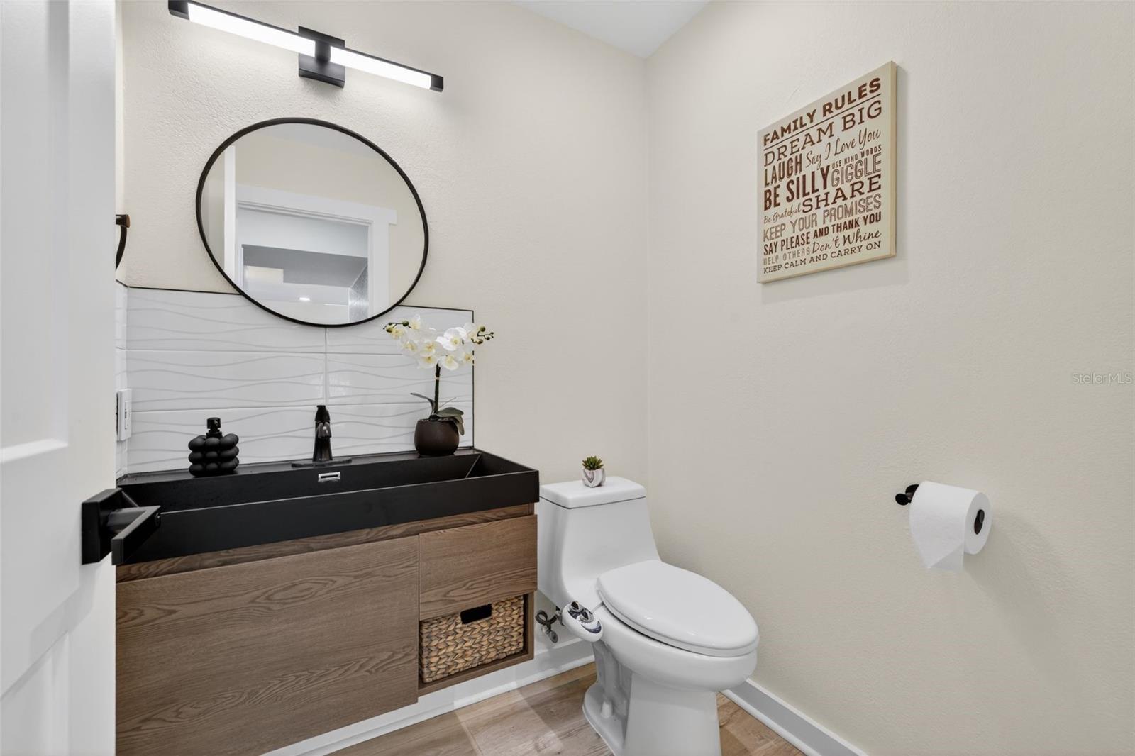 The first floor features a half bath, perfect for guests. Toilet/bidet combo.