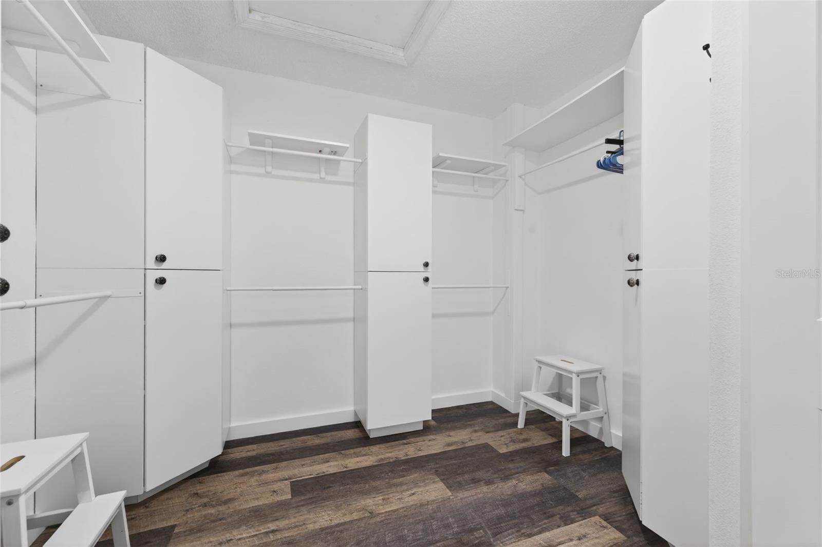 Master bedroom features a large walk in closet with built in cabinetry, ample hanging space, shelving, and room for a full wardrobe collection.