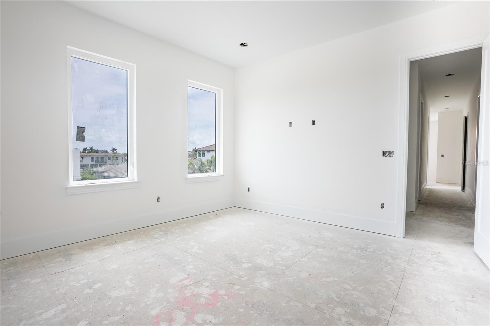 Spacious Primary with tray ceilings and access to balcony overlooking view and pool