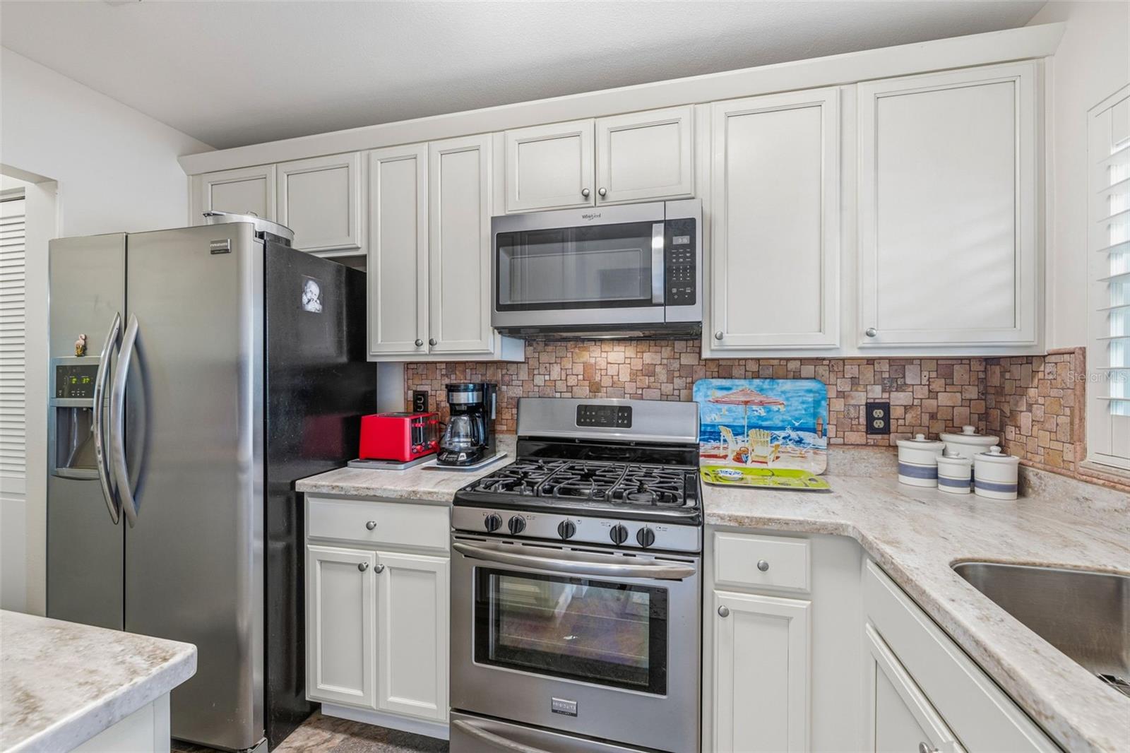 Kitchen with stainless appliances and ample storage