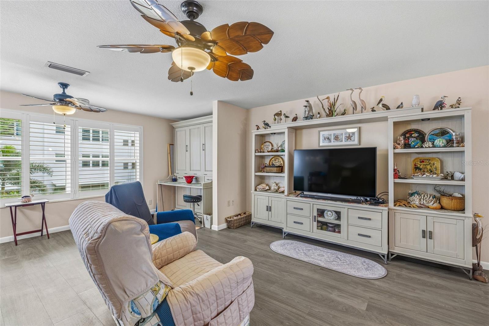 Living room with built in storage and seating area