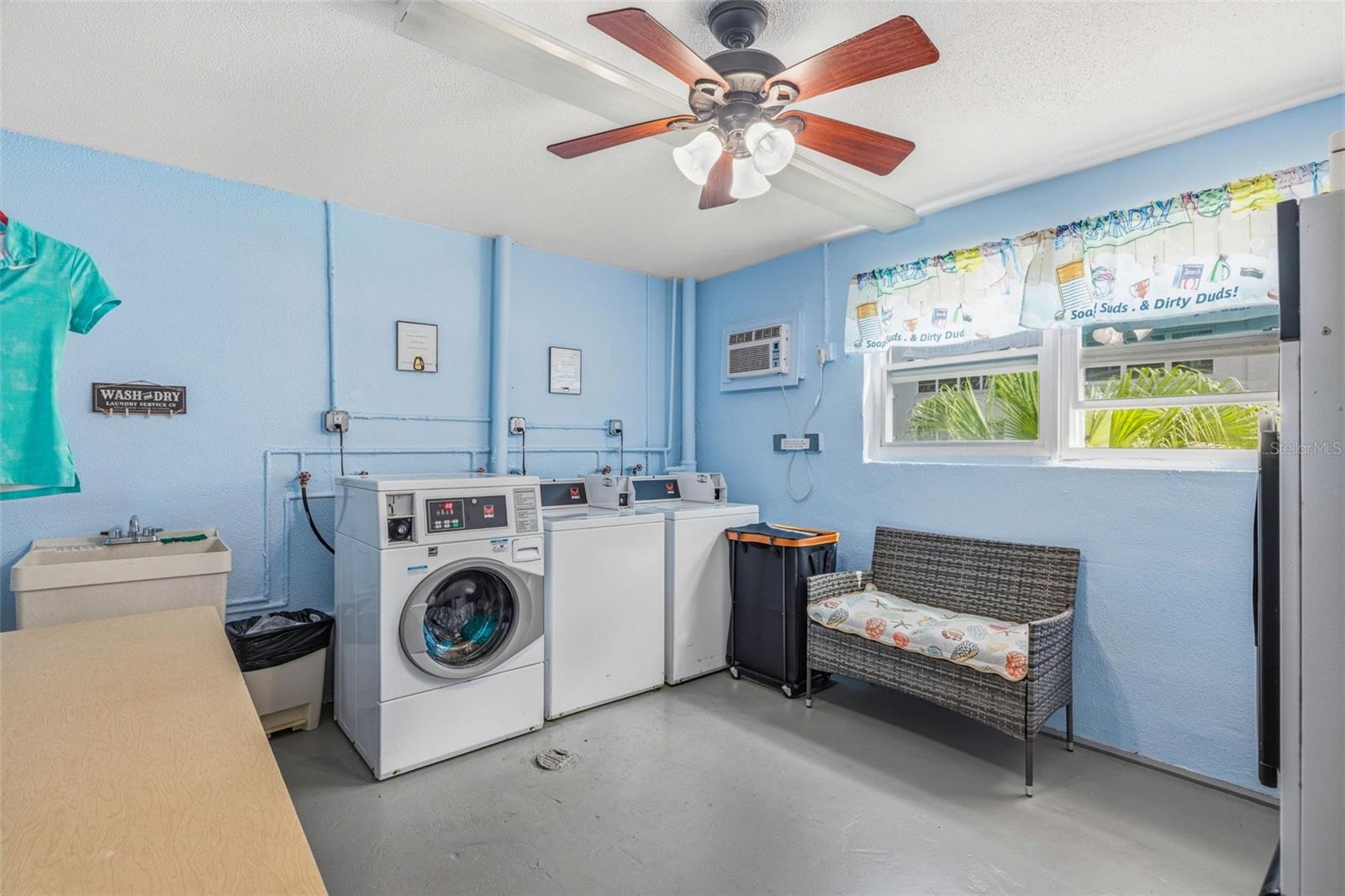 Community laundry room with washer and dryer