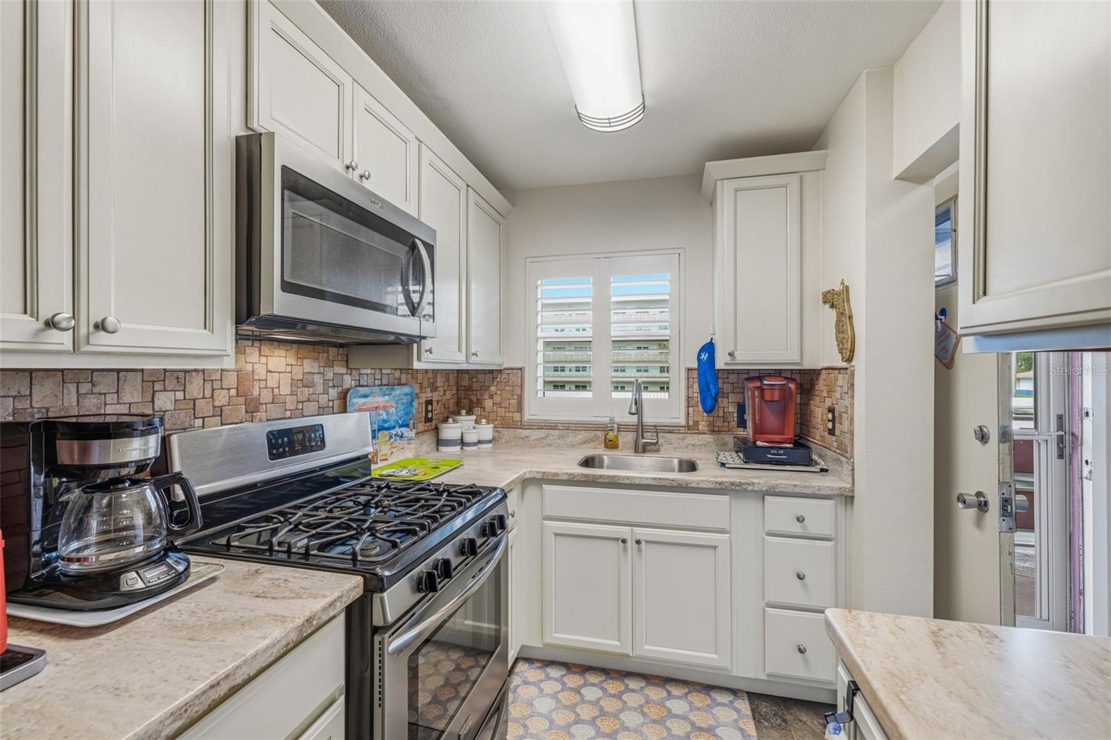 Galley kitchen layout with bright lighting