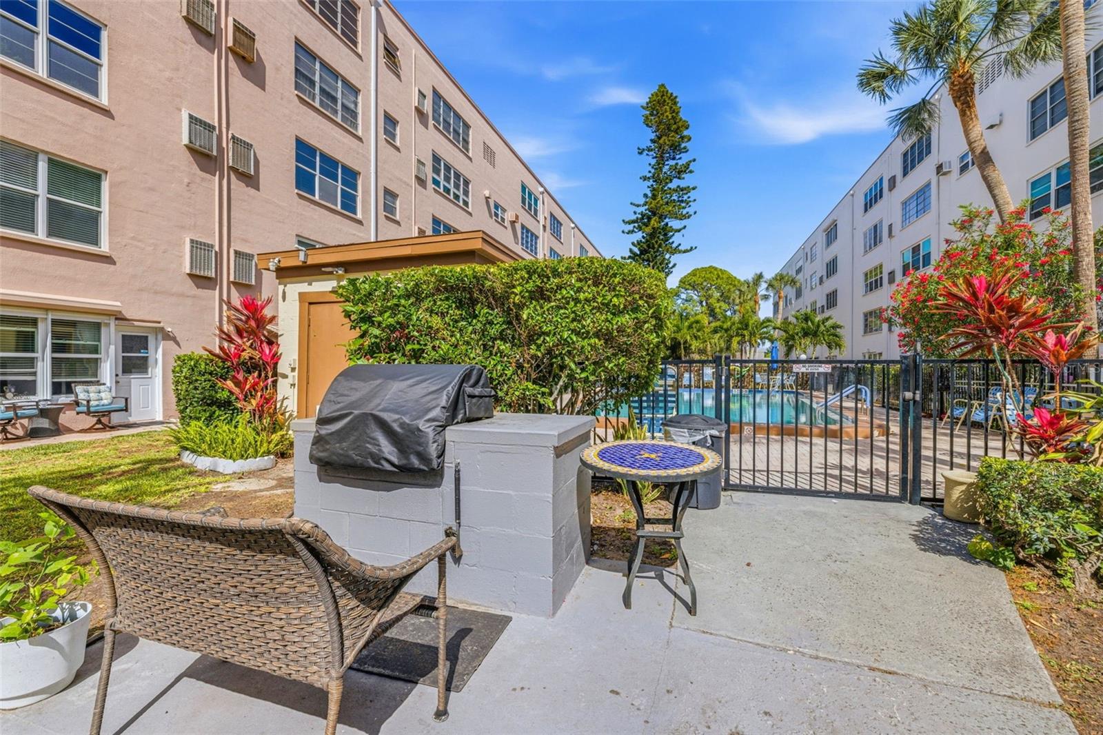 Outdoor grill and patio by pool