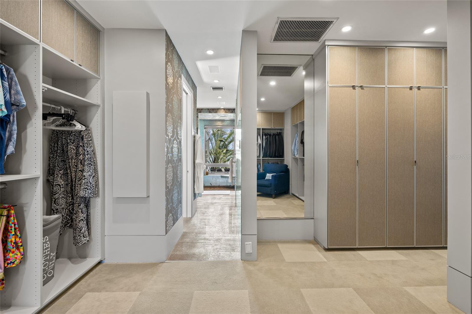 Generous dressing area with custom built-ins and abundant storage