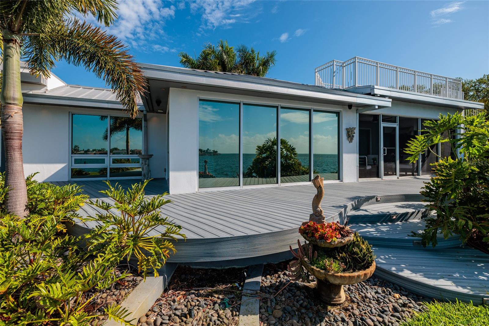 Expansive waterfront deck with floor-to-ceiling bayfront views