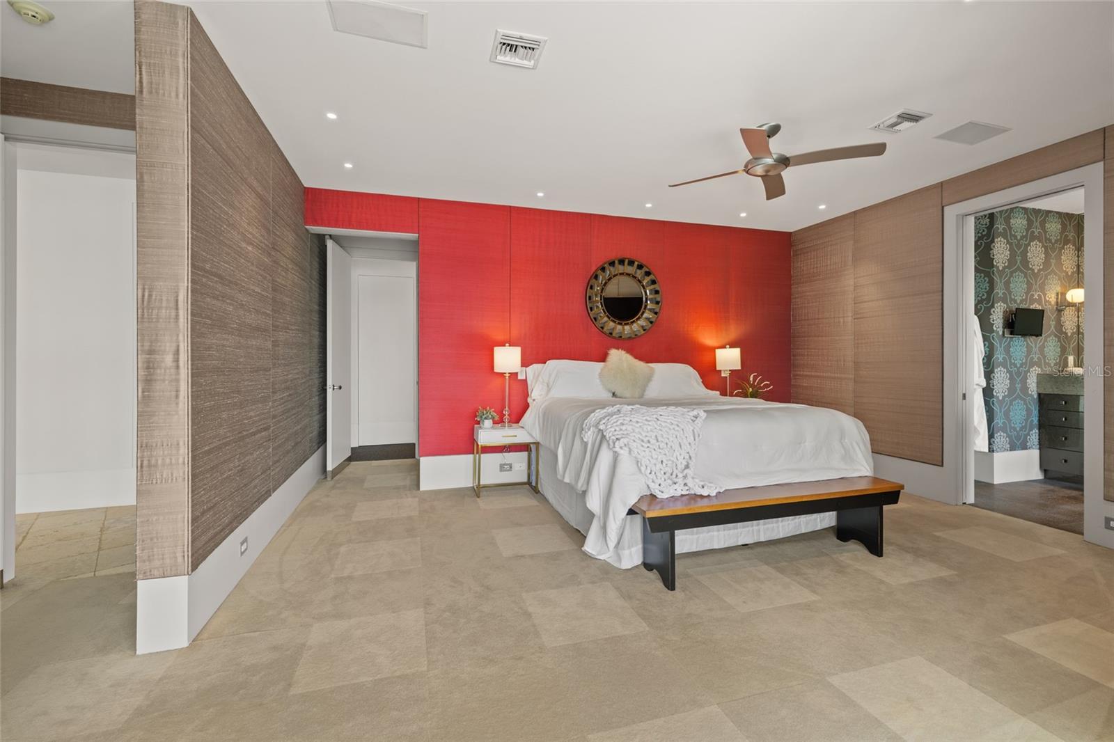 Spacious primary suite with designer finishes and sophisticated accent wall