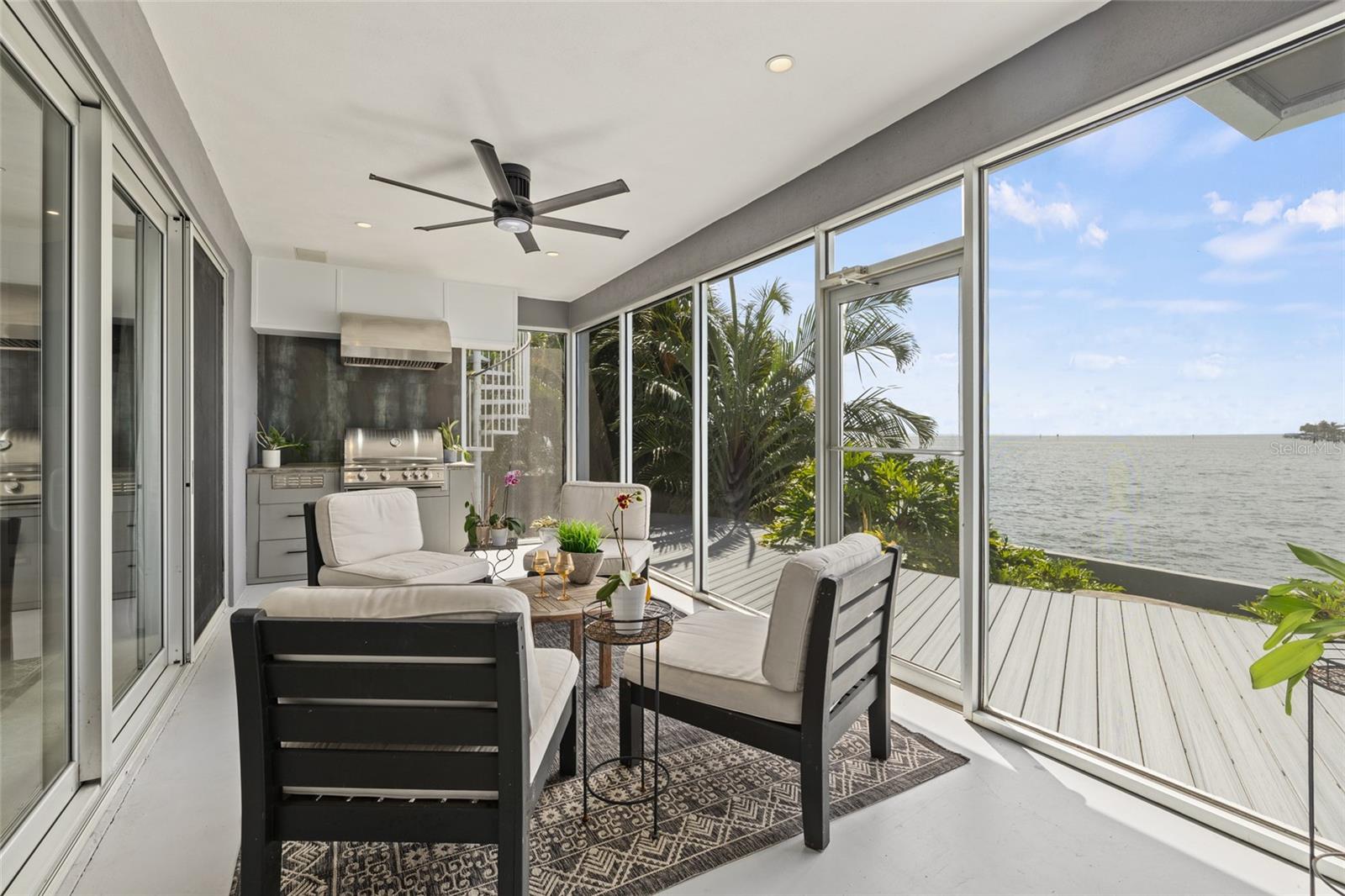 Inviting outdoor lounge with grill station and panoramic water views