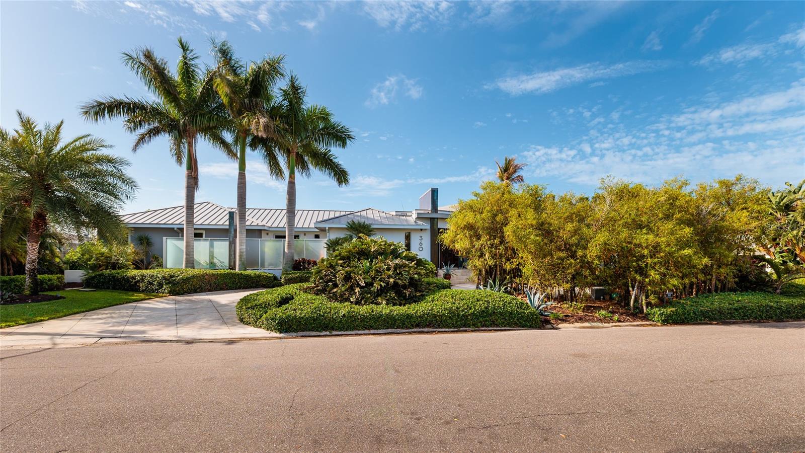 Circular drive for guests to visit and lush landscaping keeps the home private.