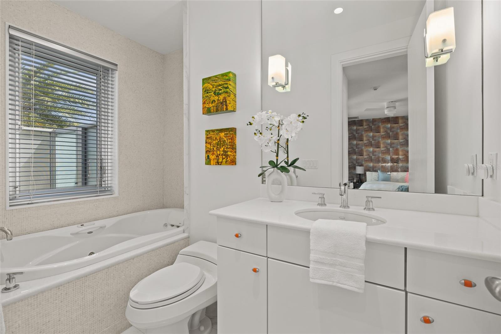 Bright en suite bath with soaking tub and crisp modern finishes