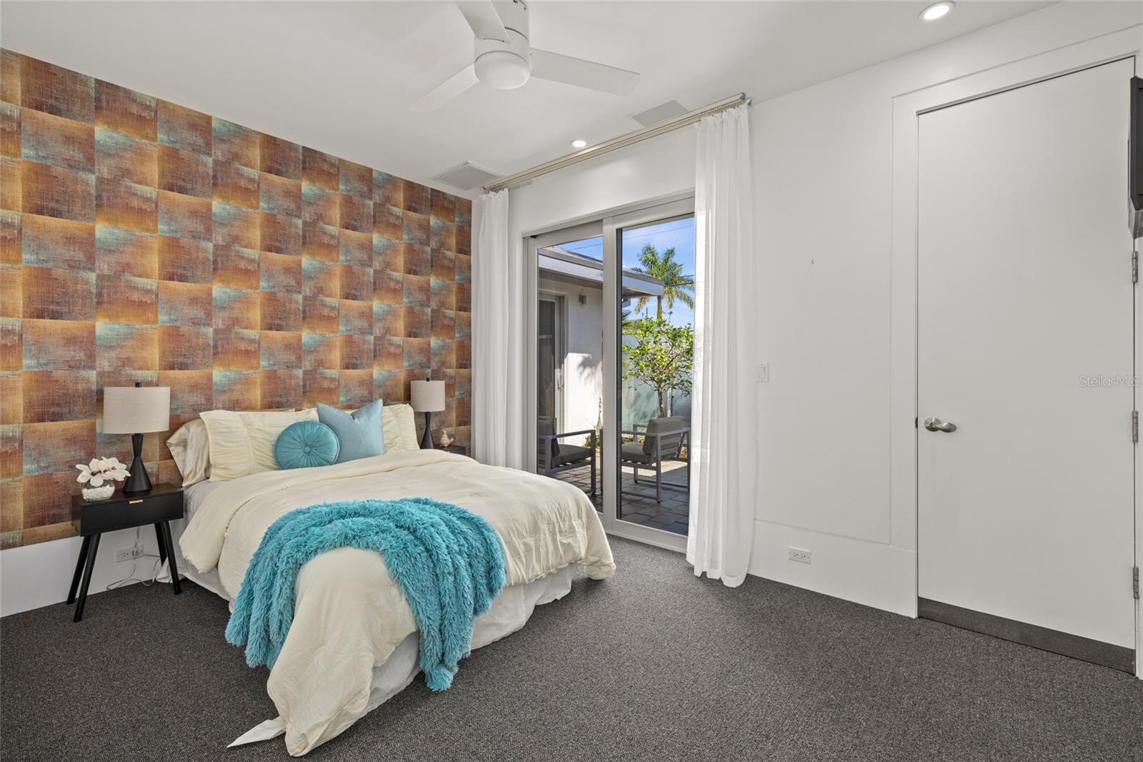 Spacious guest bedroom with sliding glass doors to the private patio